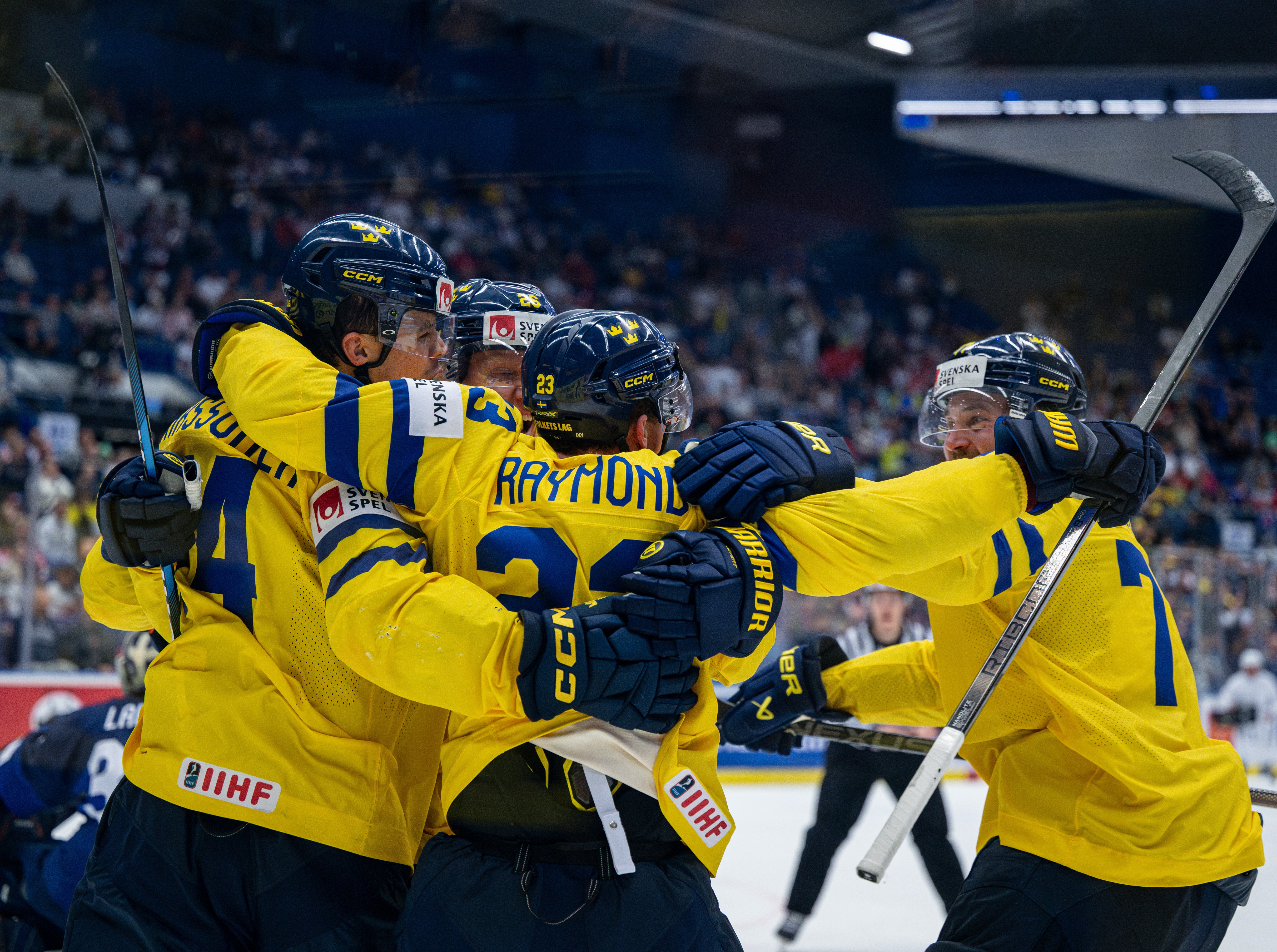 Svenska hockeylandslaget Tre Kronor firar ett mål under världsmästerskapet med kramar och glädje.