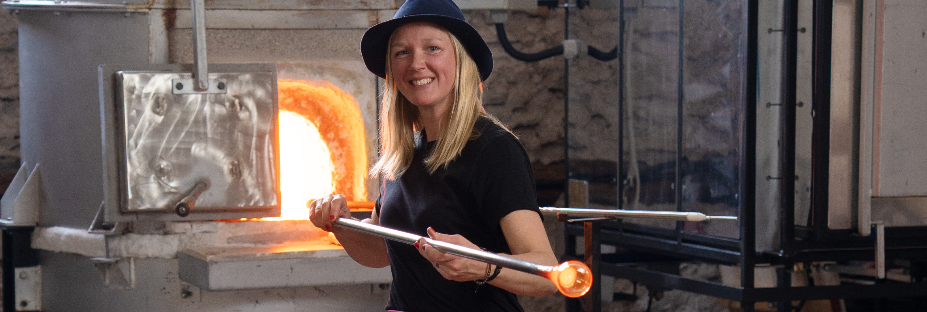 Jennie Jessen framför en glasugn i hennes studio