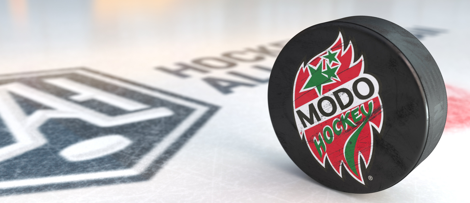 Hockeypuck med Modos logga